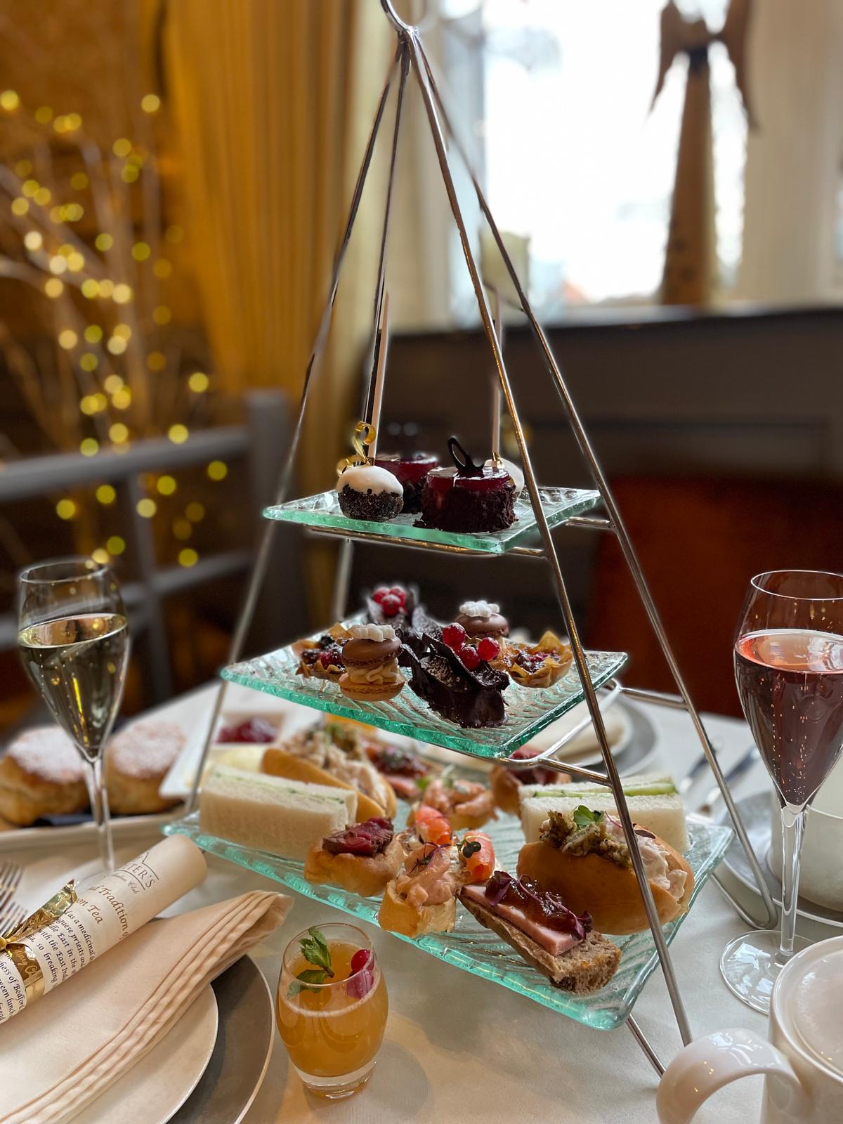 A close view of a three-tier afternoon tea with handmade savouries and desserts